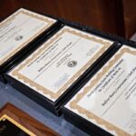 Three NC Building Commission Certificates of Merit are displayed on a table