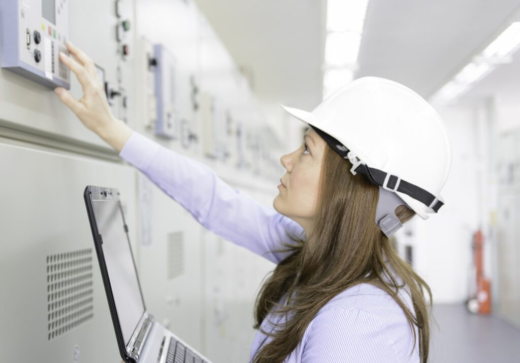 Female engineer is checking equipment in power substation