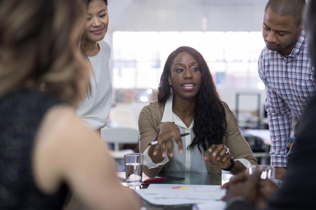 Closeup of woman leading team sitting at a table